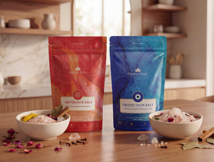 Two salt packages, one red and one blue, on a kitchen counter with bowls of salt and spices.