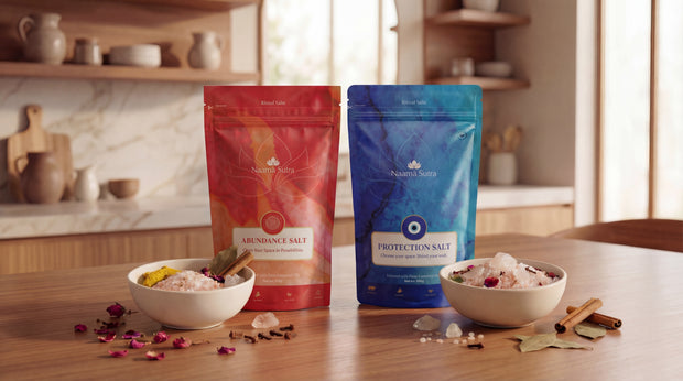 Two salt packages, one red and one blue, on a kitchen counter with bowls of salt and spices.
